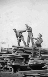 John Crimmons, William McGraw, and Richard Gaul in a Lumber Yard at Los Alamos , 1946